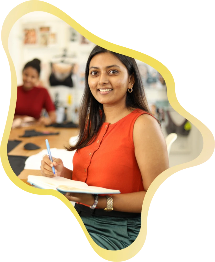 A MAS team member smiling while working at her desk