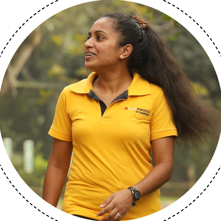 An MAS Abhimani role model in a yellow polo shirt walking outdoors