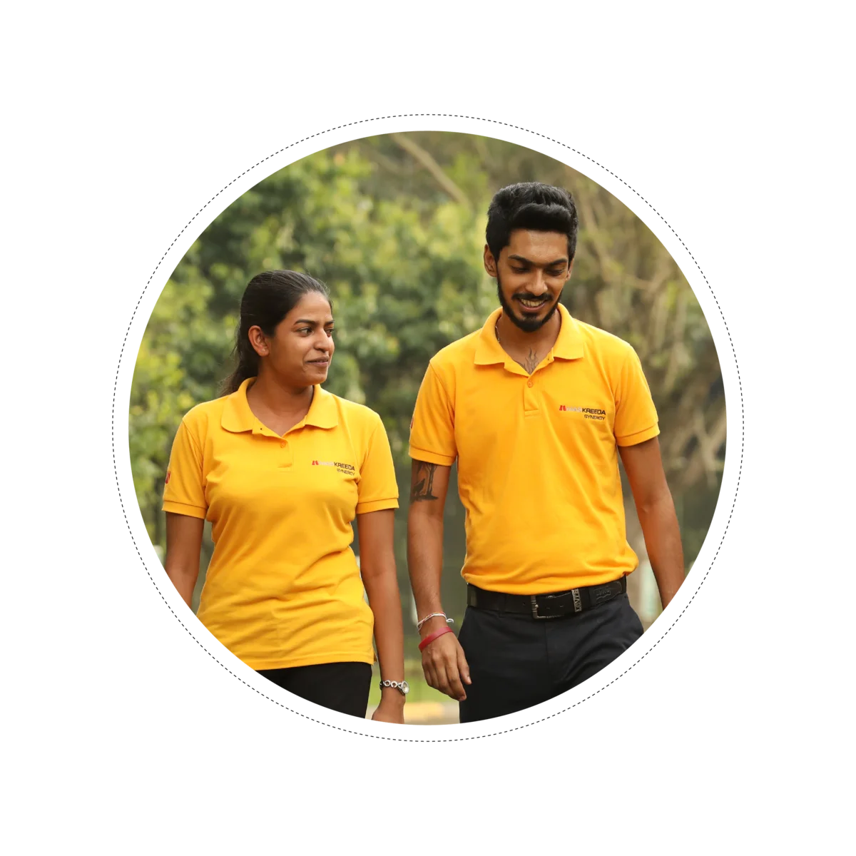 Two MAS employees in yellow MAS polo shirts walking outdoors