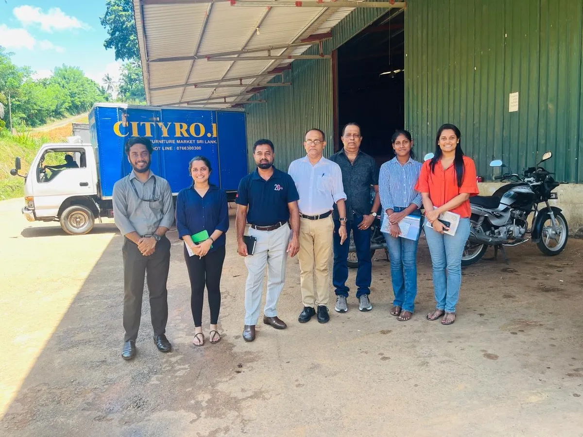 A group standing in front of a CITY RO recycling-partner truck during a facility visit